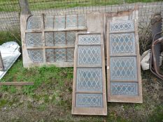 Two four-pane lead-glazed wooden panels and a matching six panel lead glazed door,