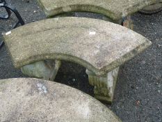 Crescent shaped concrete garden seat.