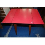 Red melamine drop down kitchen table.