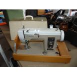 Cased New Home electric sewing machine.