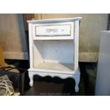 A white painted bedside cabinet.