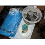 A tarpaulin, a box of metal brackets and bird feeders.