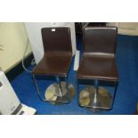 Pair of chrome base faux leather swivel chairs.