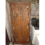 Softwood eight plank in frame wooden door approx. 77" high x 33" wide.