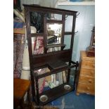 A dark stained Oak Hall stand having bevelled mirror,