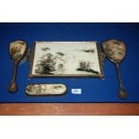 An oriental print tray with mirror and two brushes.