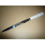 An onyx handled paper knife/letter opener the blade engraved "M&G. Re.