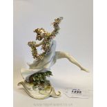 A Capodimonte dancing nymph with garlands of flowers, 7" tall.