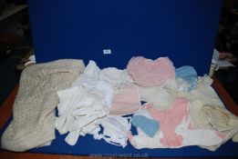 A quantity of vintage baby knitted clothes, crocheted shawl, plastic pants, tights, etc.