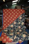 A hand sewn reversible quilted bedspread in brown with yellow flowers to one side and larger floral