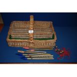 A 1930's wicker Cutlery Tray and a quantity of 1930's Penny Whistles.