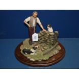 A Country Artists figure group of Farmer and Collies, 14'' long x 10'' tall.