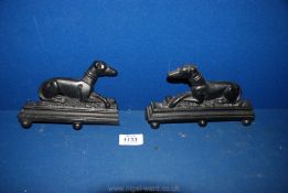 A pair of metal Doorstops in the form of Greyhounds resting, one a/f.