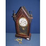 A Jerome wooden cased and glass fronted eight day mantle Clock with key.