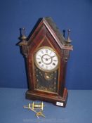 A Jerome wooden cased and glass fronted eight day mantle Clock with key.