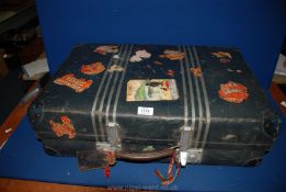 A vintage Suitcase having leather handle and travel stickers including Italy, Milan, etc.