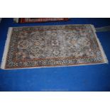 A contemporary bordered, patterned and fringed Eastern Rug,