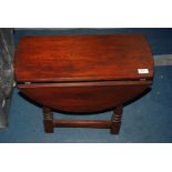 An oval Oak drop-leaf occasional Table, 18'' high.