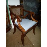An attractive sabre legged Mahogany framed open armed Elbow Chair having reeded arms and backrest