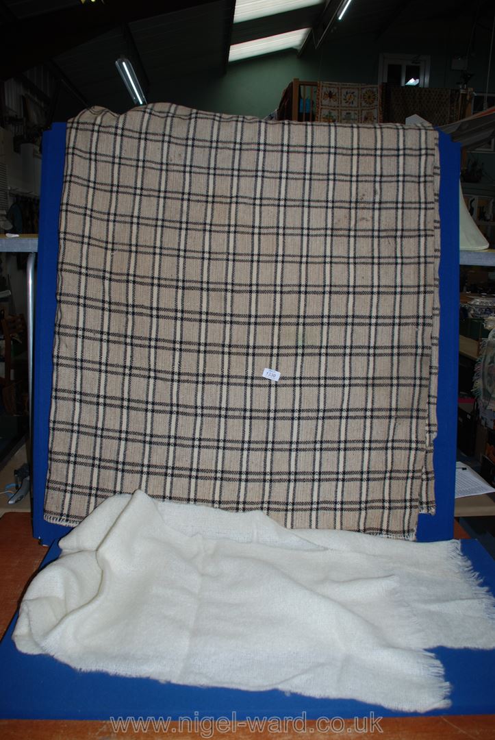 A double wool Blanket in brown and black check (some holes) and a cream woollen shawl.