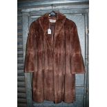 A three quarter length fur coat by Augustus Edwards, Hereford.