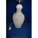 A continental porcelain Table Lamp with profusely embossed floral and branch decoration, with shade,