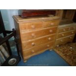 A Pine Chest of three long and two short Drawers with turned wood knobs and turned feet and of good