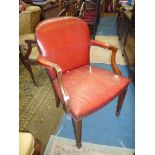 A red hide upholstered open armed Elbow Chair having tapering square front legs terminating in