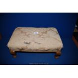 A rectangular beige upholstered (requires cleaning) Stool standing on brief cabriole legs,