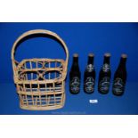 Four bottles of Whitbread silver jubilee Beer 1977, in wicker bottle carrier.