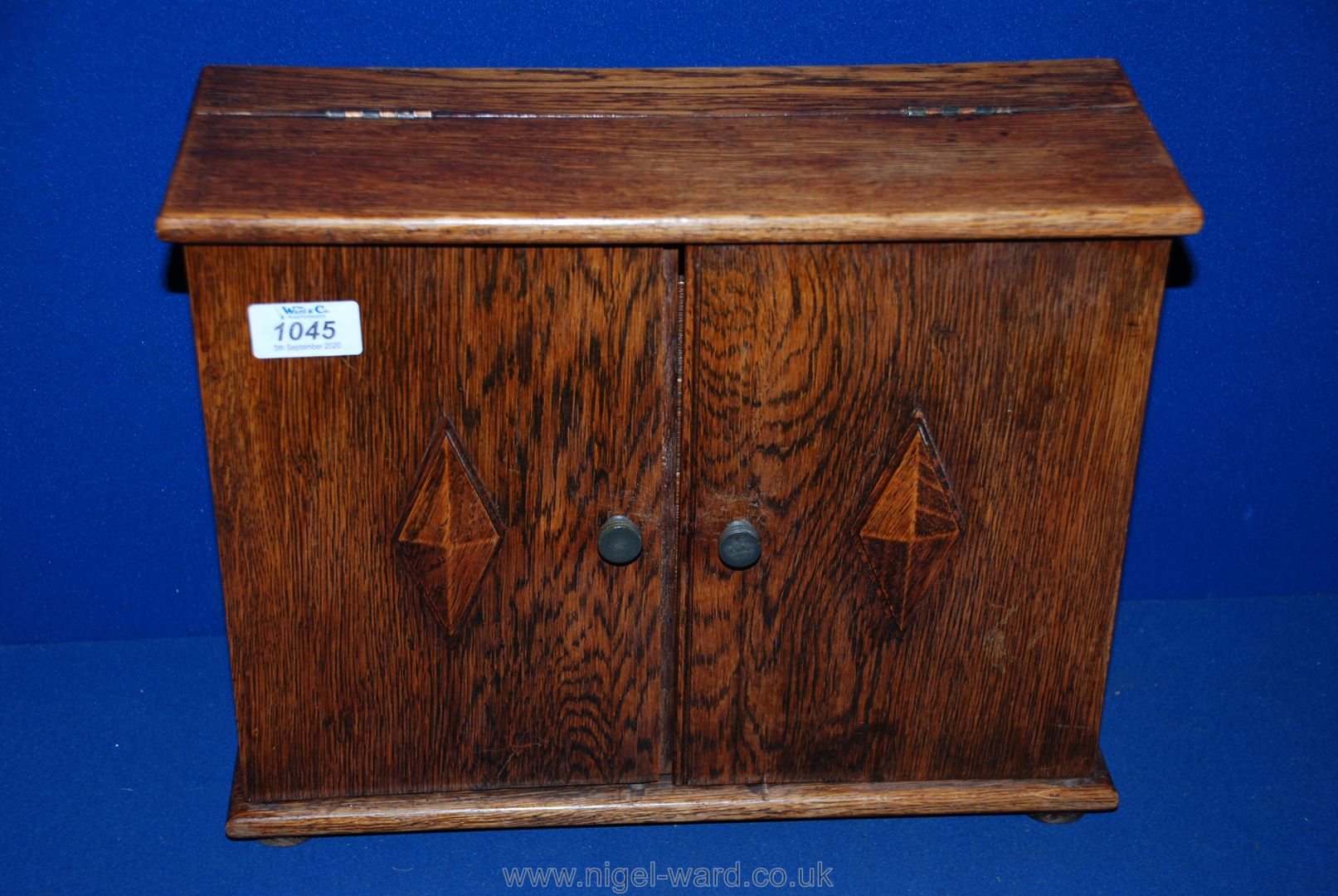 An Oak Stationery Cabinet opening to reveal three letter racks and one drawer to base,