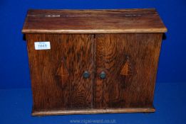 An Oak Stationery Cabinet opening to reveal three letter racks and one drawer to base,