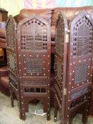 A heavy Eastern hardwood pierced worked and brass studded four-fold Screen,