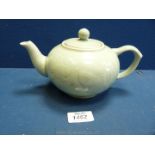 A pretty oriental Teapot in pale green with fish decoration and four character mark to base in