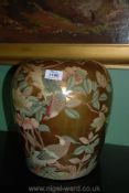 A large modern Japanese Urn in floral and bird decoration on a gold ground, 12'' tall.