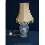 A blue and white table Lamp and shade, 16" tall.