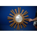 A wooden framed Sunray battery operated Wall Clock with face, Roman numerals and ship design,
