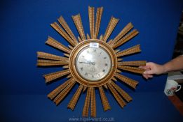 A wooden framed Sunray battery operated Wall Clock with face, Roman numerals and ship design,