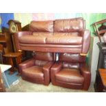A brown Leather three piece Lounge Suite comprising a three seater settee and pair of easy Chairs