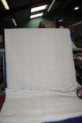 A pair of single cotton bedspreads in pale cream square pattern.