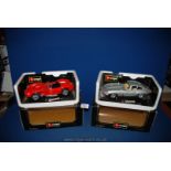 Two Burago model cars including red Ferrari Testarossa 1957 and silver Jaguar 'E' type Coupe 1961.