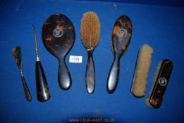 A quantity of Tortoiseshell monogrammed with 'W' including mirror, two brushes, shoe horn,