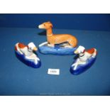 A pair of 19th c. Staffordshire pottery Greyhound pen holder figures plus another with leg a/f.