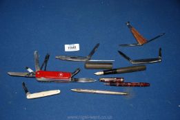 A quantity of miscellanea including a Swiss Army penknife and four others, fountain pens,