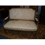 An antique Louis XVI design carved gilt wood Sofa standing on turned and fluted legs and with