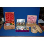 A box of small wicker baskets and tins with contents of cotton reels, threads,