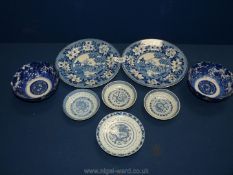 A quantity of blue and white plates including Chinese rice bowl saucers, two rice bowls,