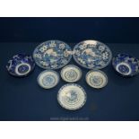 A quantity of blue and white plates including Chinese rice bowl saucers, two rice bowls,