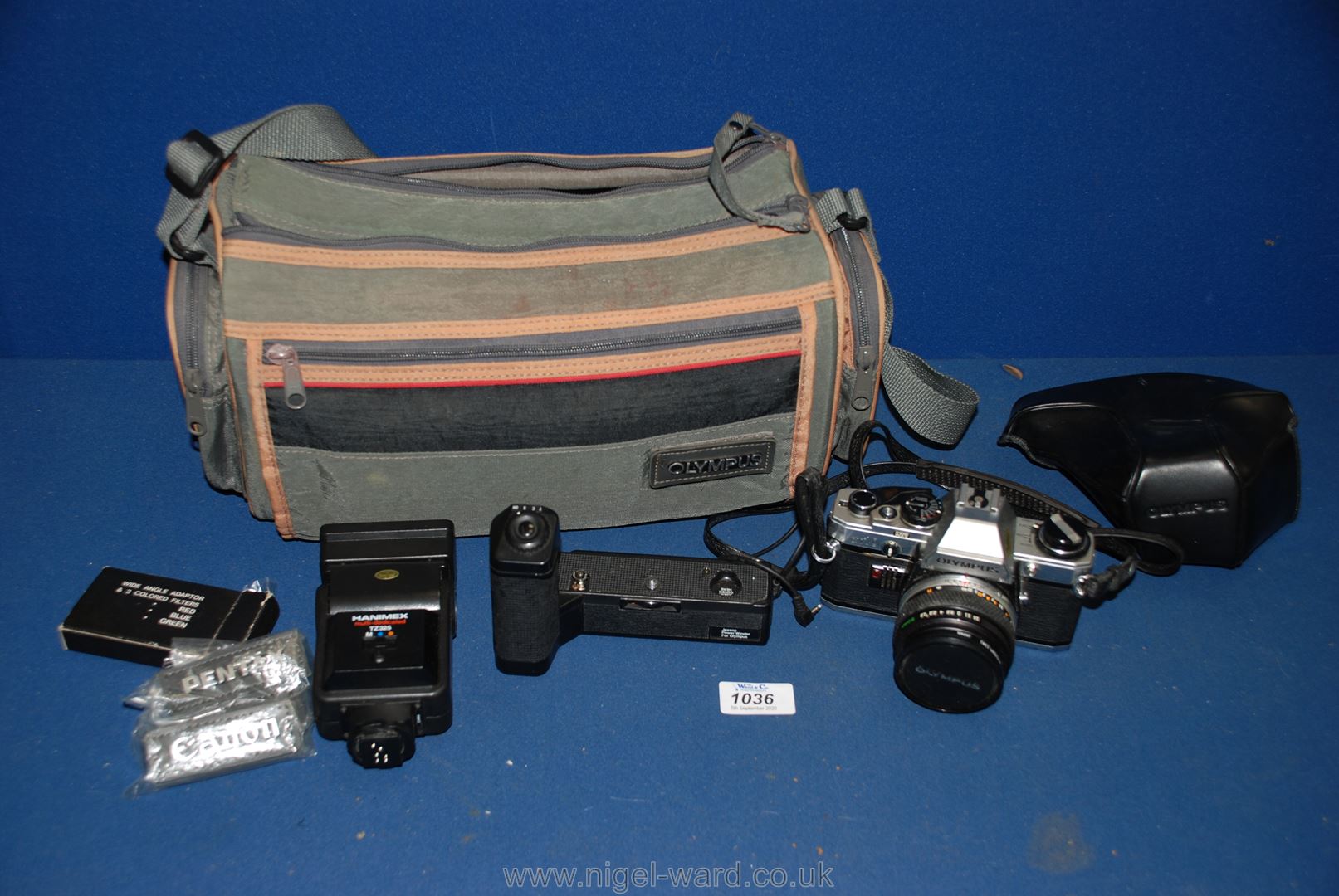 An Olympus OM-10 35 mm SLR camera with Olympus lens, OM-1TR dedicated power wind,