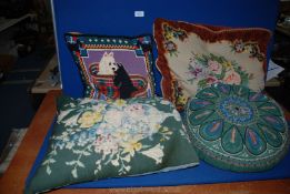 Three needlepoint Cushions and one circular embroidered cushion.